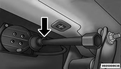 Rotate the wheel wrench handle counterclockwise until the spare tire is on the