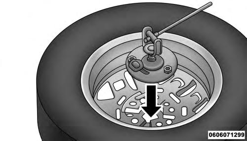 340 WHAT TO DO IN EMERGENCIES Alloy Wheel Mounting 4. Position the tire vertically and lay the mounted adapter on the inner part of the rim.