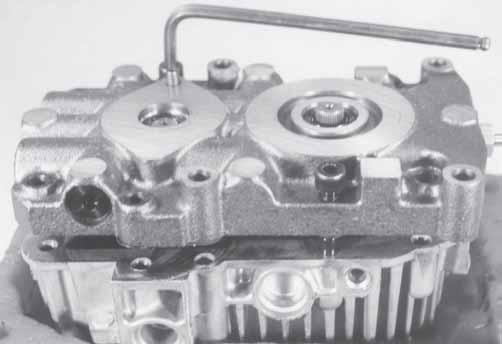 CAUTION: The cylinder blocks may stick to the surface of the center section. Exercise caution to prevent damage to the components. Remove the gasket and two aligning pins from the housing.