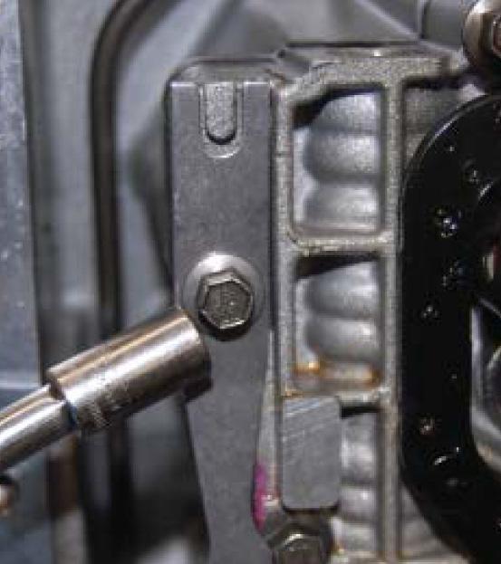 Remove the two bolts that hold the Neutral Position Sensor in place then remove