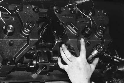7 Carefully position the three engine brake housings on the engine.