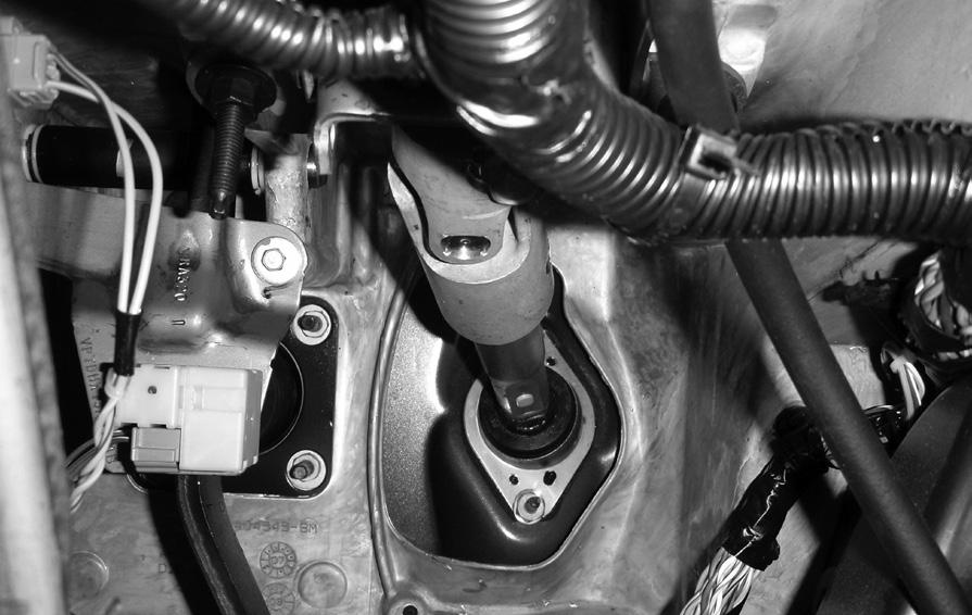Part v: STEERING SHAFT RELOCATION In order to provide ample clearance between the steering shaft, ignition coils, and valve cover, a relocation bracket is provided.