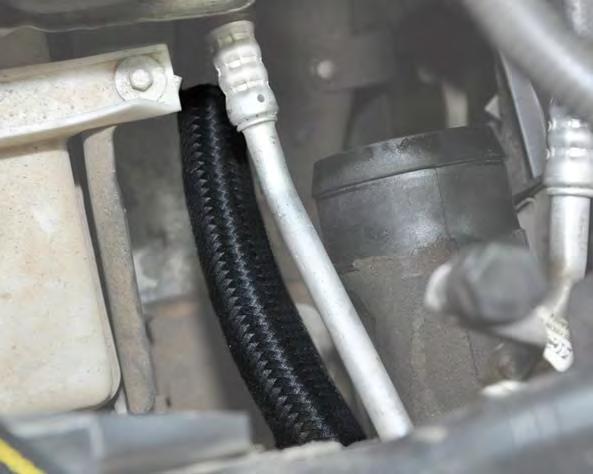 Route the hose through the core support where the A/C hoses and intercooler come
