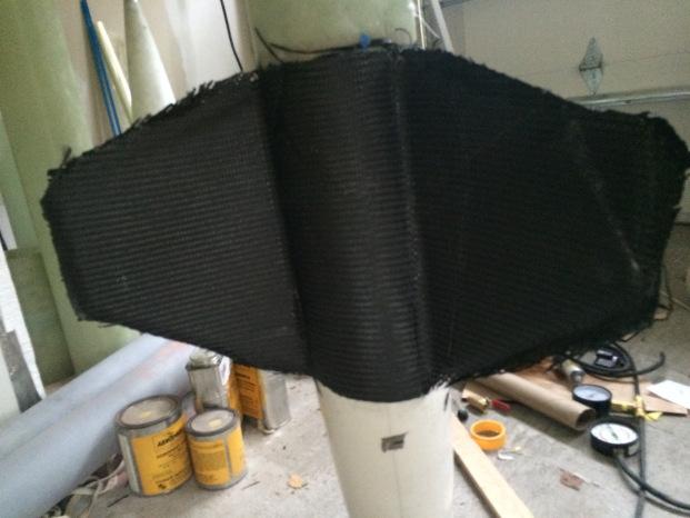 Two layers of 2 2 carbon were laid tip to tip on the fins, and the setup was vacuum bagged.