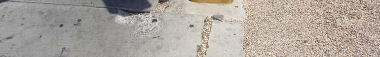 Photo 32: Damaged Sidewalk and Low Pull Box on Southeast Corner at Spencer Street and