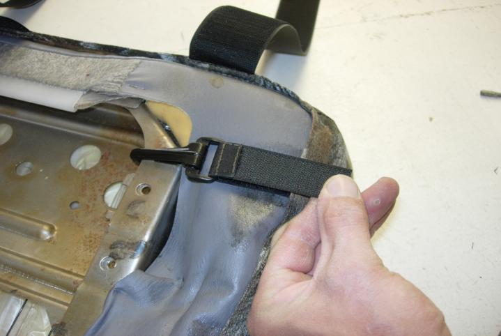 seat. The outside strap feeds through the seat bracket in front. When properly attached it should look like this.