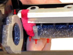 Install the cleaned Primary Corona Assembly by dropping it in right side first, but flush with the left edge, aligning the tabs