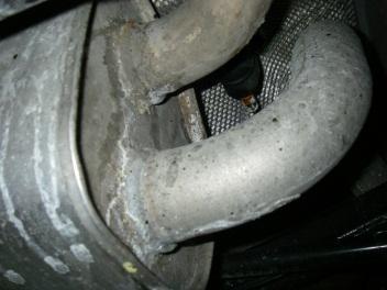 Cut the tailpipe off where it exits the muffler, then remove the hanger on the tailpipe from the rubber mount on the vehicle and lower the tailpipe