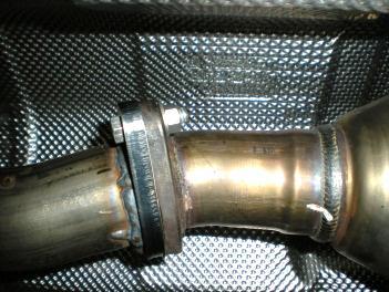 4) Support the large center muffler with a stand and remove the two nuts at the flanged connection just behind the catalytic converter.