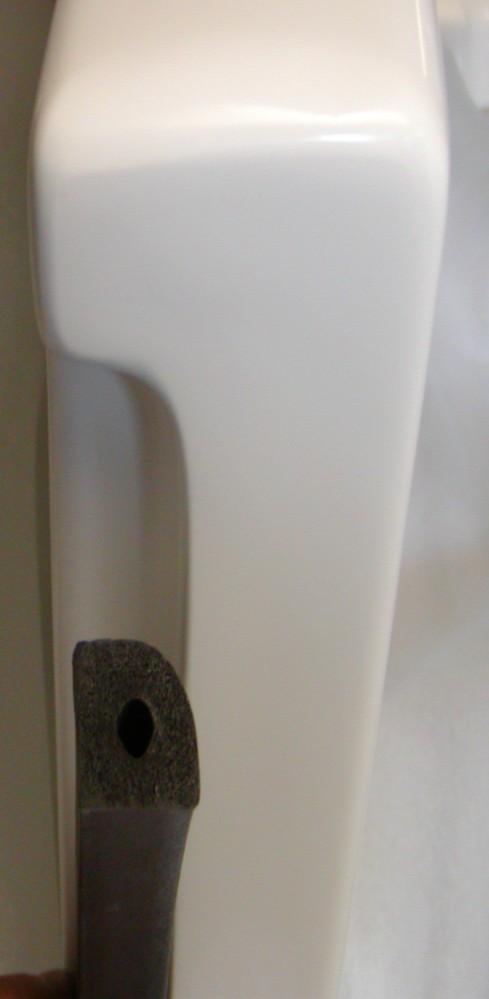 REPLACING AN RR7 DOOR SEAL CONTENTS OF DOOR SEAL Rubber Door Seal Two (2) Black Push Pins Contact Cement Sandpaper Brush INSTRUCTIONS 1.