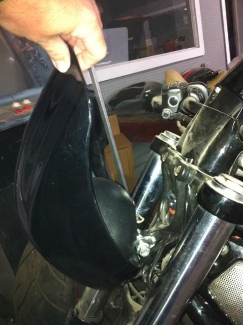 4. Rotate the fairing forward by grabbing the top and firmly pulling it forward. 5.