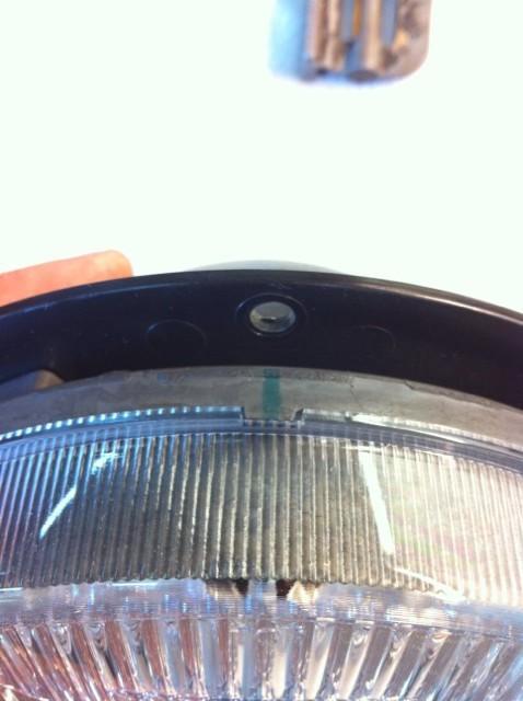 Use the plastic housing that you removed from the back of the factory headlight to mark the orientation of the 5 holes onto