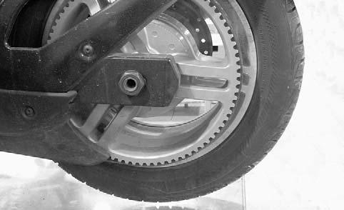 Turn rear wheel to align a wheel spoke with the swing arm. 8. Tap the belt to make the belt vibrate and read the measurement. 9. Take a second measurement to confirm the first one.