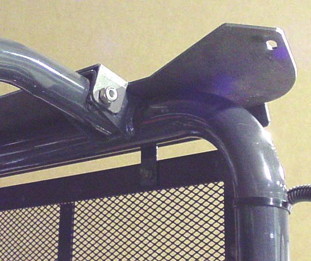 Rev. K, p. 7 of 19 2. FRONT MOUNT 2.1 With assistance, install the front mount as shown in fig ure 2.1. Use the two original equipment M10 bolts found in the front overhead ROPS tubing.