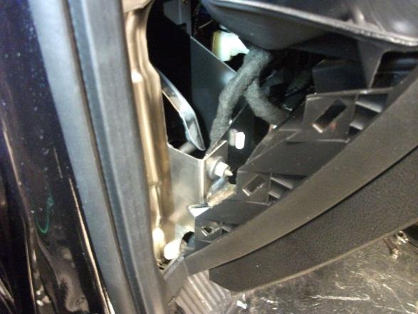 Remove the two screws securing the module to the left of the brake pedal.