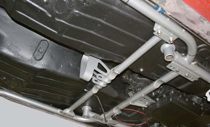 The Torque Arm cross-member is installed with the driveshaft loop facing rearward and the end flanges of the cross-member under the brackets on the sub-frame connectors.