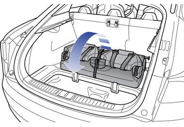 Pull the strap at the rear of the seat to fold the seat assembly into the trunk floor. 5.