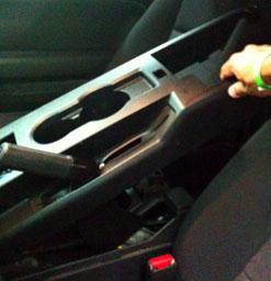 4. Lift the center console cover starting from rear and sliding it over the