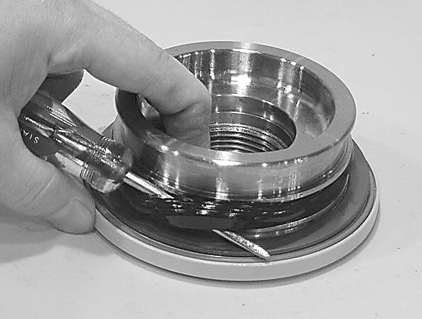 Beginning with the inner seal (200) insert one end of backup ring in the lower groove and feed the