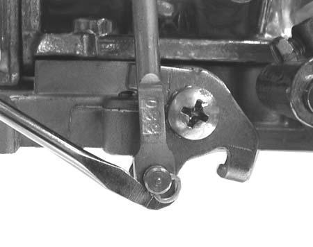 3. Remove the clip retaining the diaphragm plunger to the secondary throttle lever using a small flat-blade screwdriver (Figure 15). Figure 15 Figure 16 4.