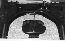 Place the wheel wrench into the bag and use the straps to secure the bag to the jack. 2. Install the jack in the driver s side panel of the rear cargo area and secure with the wing bolt. 3.