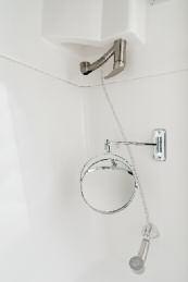 Our custom molded fiberglass shower surrounds house a ceramic toilet