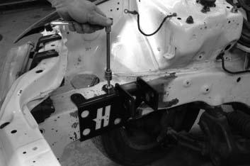 Preparing the Engine and Engine Bay: 7 Slide the bracket back on the frame rail and thread the two