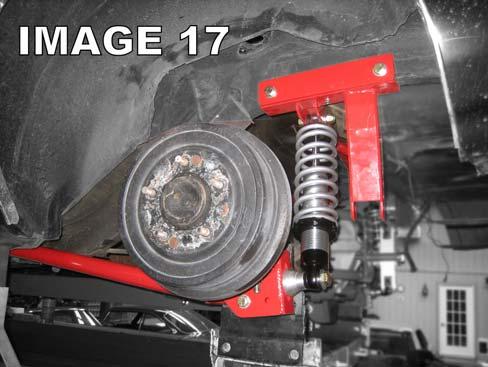Place a spring over the shock and then insert the upper spring mount on top of the spring and over the shock shaft.