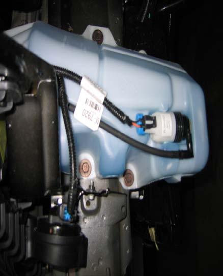26 Locate the windshield washer reservoir on the driver s side of the vehicle. Place a pan under the reservoir, disconnect the main line found on the side of the reservoir, and drain.