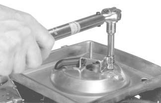 properly seated (collars sealed against each side of base). See Figure 11-88. Figure 11-90. Torquing Base Screws. Figure 11-88. Pulling Breather Hose through Base.