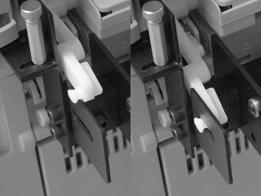 13. Ease the white plastic bracket arm on the printer (both sides) carefully inward and then down until the mounting peg inserts into the slot on the mounting bracket.