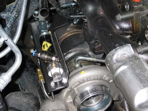 Disconnect the Intake Air Temperature (IAT) sensor harness and remove the turbo air inlet tube.