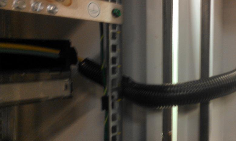 Figure 10: Loom tubing routed around hinge point and rail. 30. Remove the shipping tape from the front of the FRME1U Fiber Enclosure shown in Figure 11.