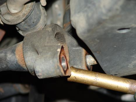 Remove the outer mounting bolt allowing the Torque Arm to swing free.