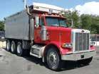 dump body with electric sliding tarp, 46,000# rears and 15,660# front axle, Hendrickson beam/block suspension, 3-stage engine brake, aluminum wheels, heated mirrors, power windows, air conditioning,