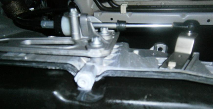 Remove the OEM lower bolt from OEM shift bracket mounted on the driver's