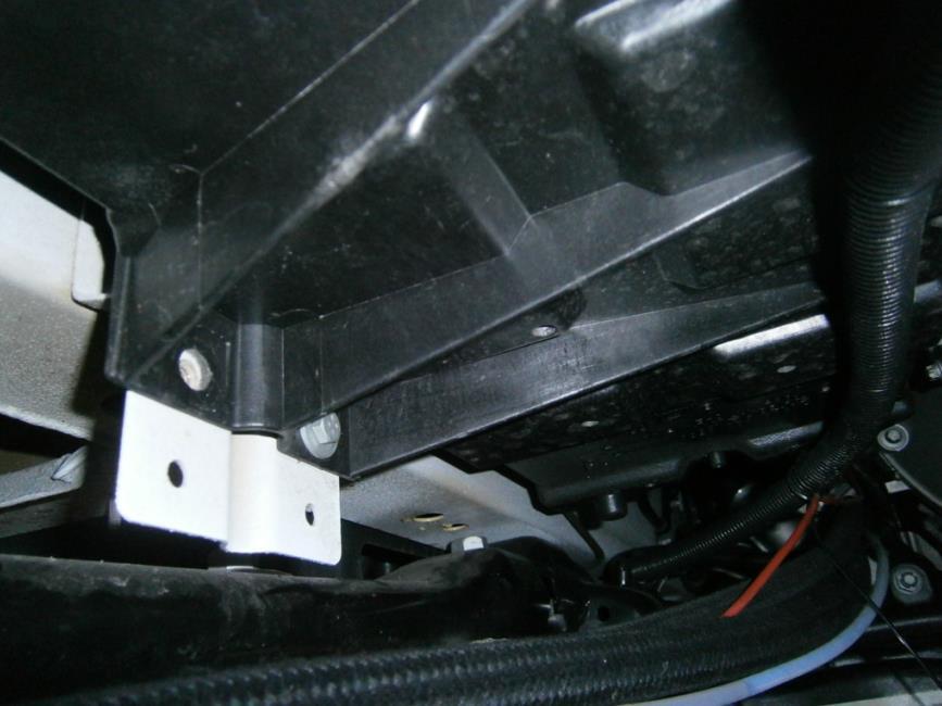 Remove and discard the OEM M6 bolt on the rear of battery box (Figure 5.7). OEM bolt (Shown removed) Figure 5.