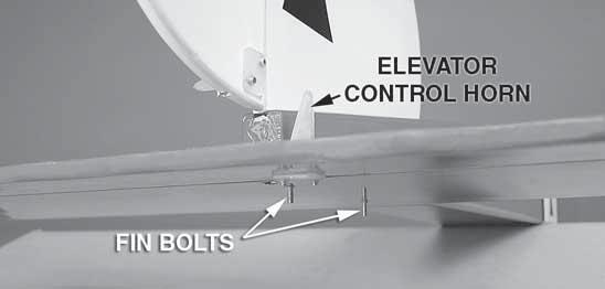 Insert the vertical fin/rudder assembly into the slot so that the two fi n bolts protrude through the bottom