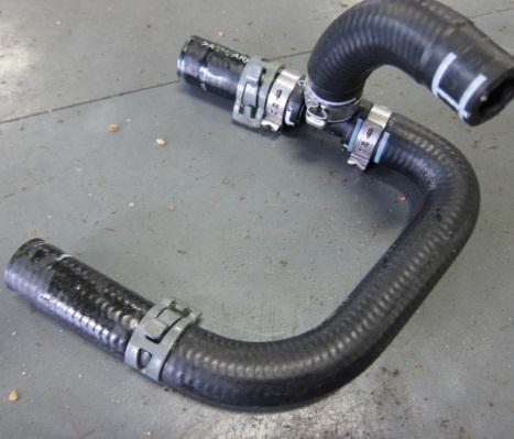 Trim U hose to join one way valve to the single intake manifold outlet.