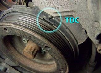 Remove the top timing belt covers (highlighted in a blue glow in this image). The covers are held in place by bolts and snap clips.
