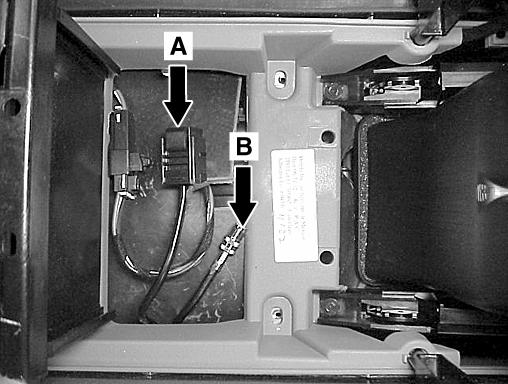 upper compartment/lid assembly by removing the two screws (A, Figure 23 [screws not visible in photo see