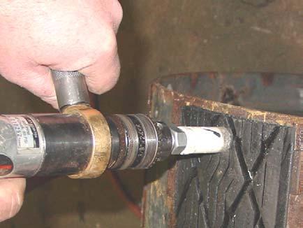 Drill out the rubber (7/8 or 1 Hole Saw or equivalent piloted on the