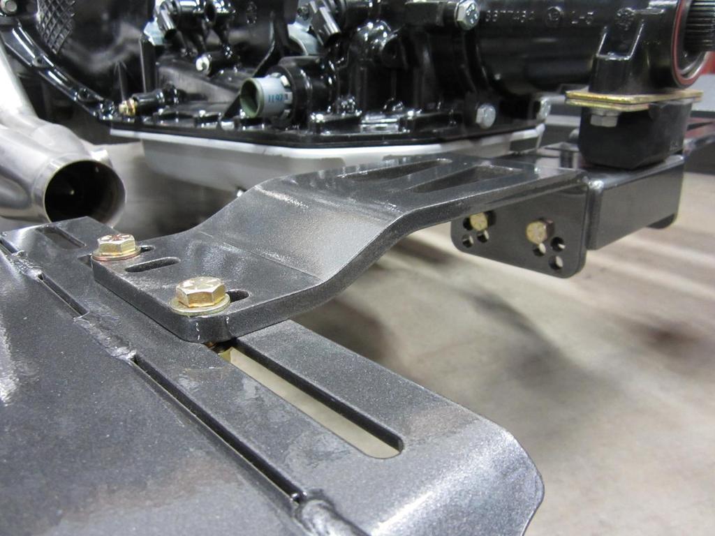 13. Install the transmission cross member. Offset top holes in center box are for LS applications.