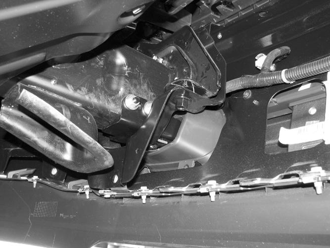 Through the radiator opening, locate the square tube support braces running up at an angle from the top of the frame channel to the bottom of the hood release mechanism, (Figures 11B, 13 & 14).
