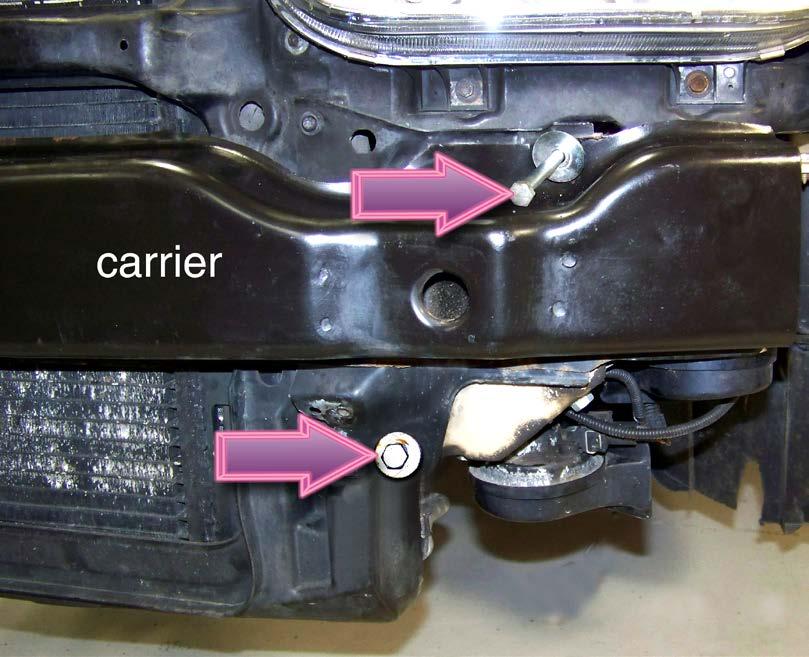 ratchet). Step 2 Using a 13mm socket and ratchet, loosen and remove the upper front bolts on both sides of the lock carrier (beneath the headlights).