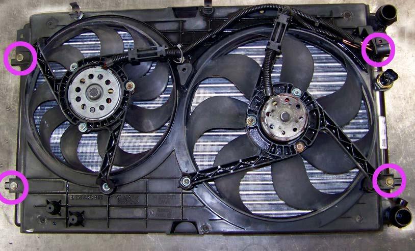 Prepare the Radiator Step 3 After cleaning away 180,000 miles of dirt, leaves, and sand, we bolt the fan shroud assembly to the new radiator,
