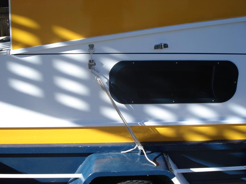 Remove outboard and reverse opening procedure. Fit door. Door requires a firm slam to compress the weather seals. Tie down very securely to trailer before transporting on a public road.