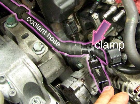 Step 9 Loosen the spring-style hose clamp and disconnect the coolant hose that runs