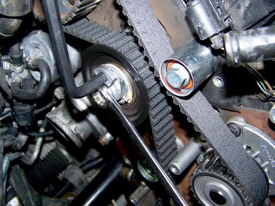 With the tensioner roller in the slack position, route the new timing belt around the sprockets at the cam, crank and water pump, as shown on page 6.