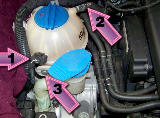Plug the hoses to prevent residual fuel from dripping into the engine compartment, and pull the hoses toward the rear of the engine compartment, out of your way.